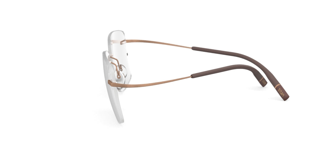 Three-quarter view of rimless prescription glasses with rose gold and brown metal arms